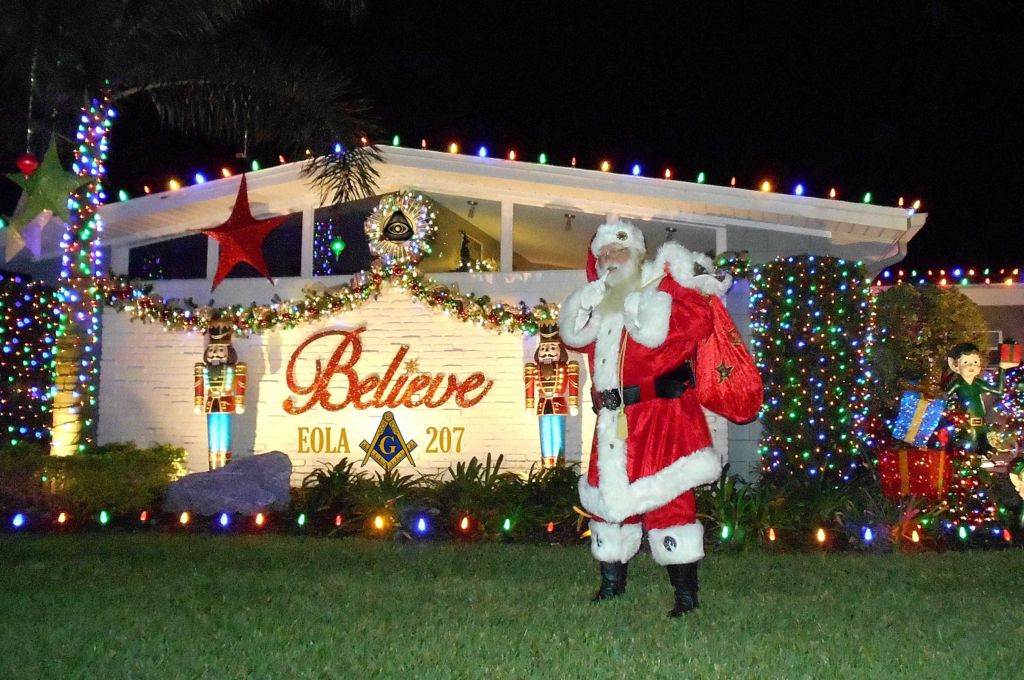 Santa Claus interacts with Christmas decorations to provide special awards